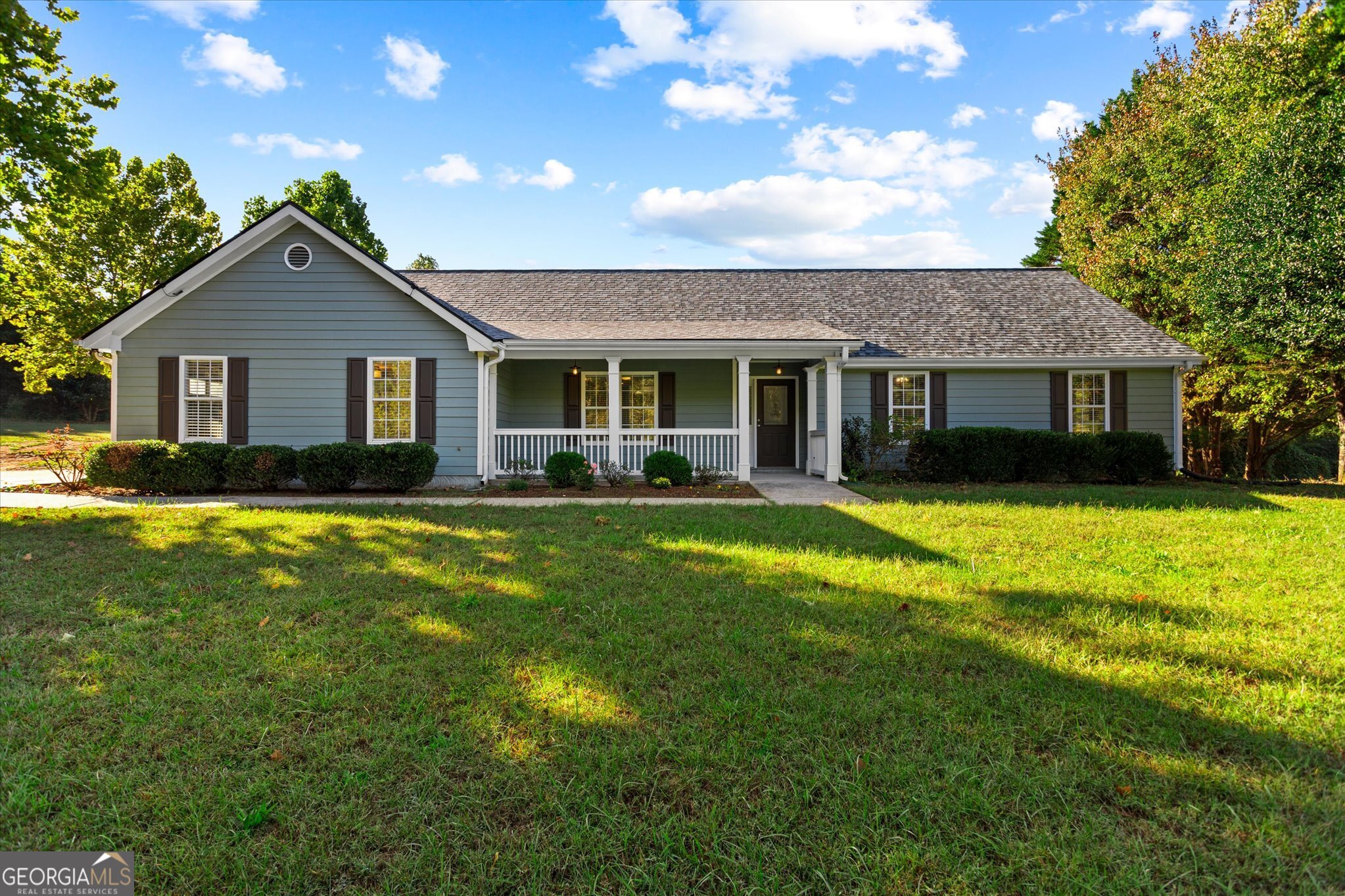 a front view of house with yard and green space