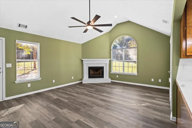 a view of a kitchen with a sink dishwasher and a fireplace
