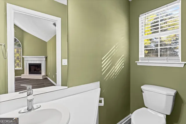 a view of a hallway with wooden floor and closet area