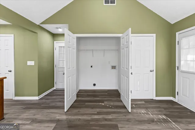 a view of a hallway with wooden floor