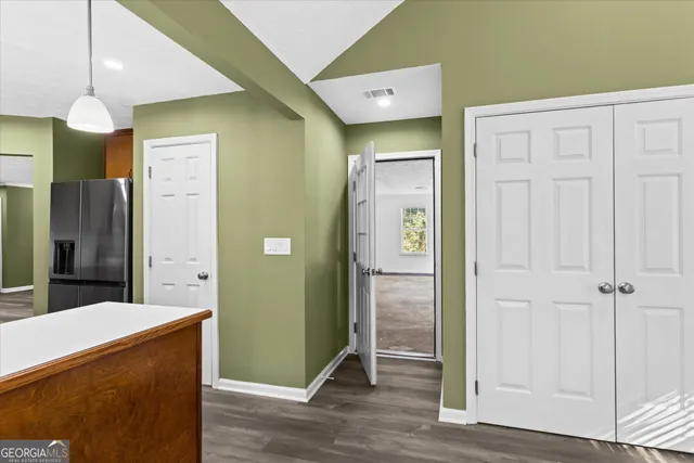 a view of a hallway with wooden floor
