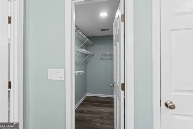 an empty room with a window and a ceiling fan