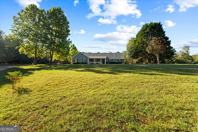 a view of a yard with swimming pool