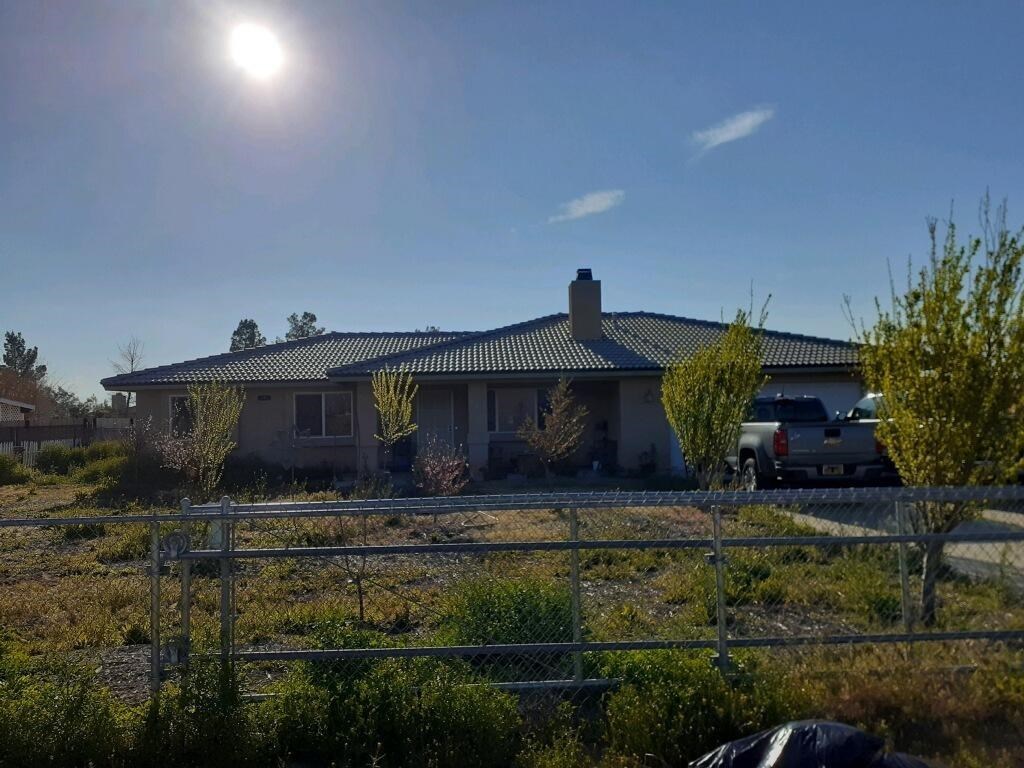 15006 Temecula Road Apple Valley, CA 92307 - Photo 1 of 13 a front view of a house with garden