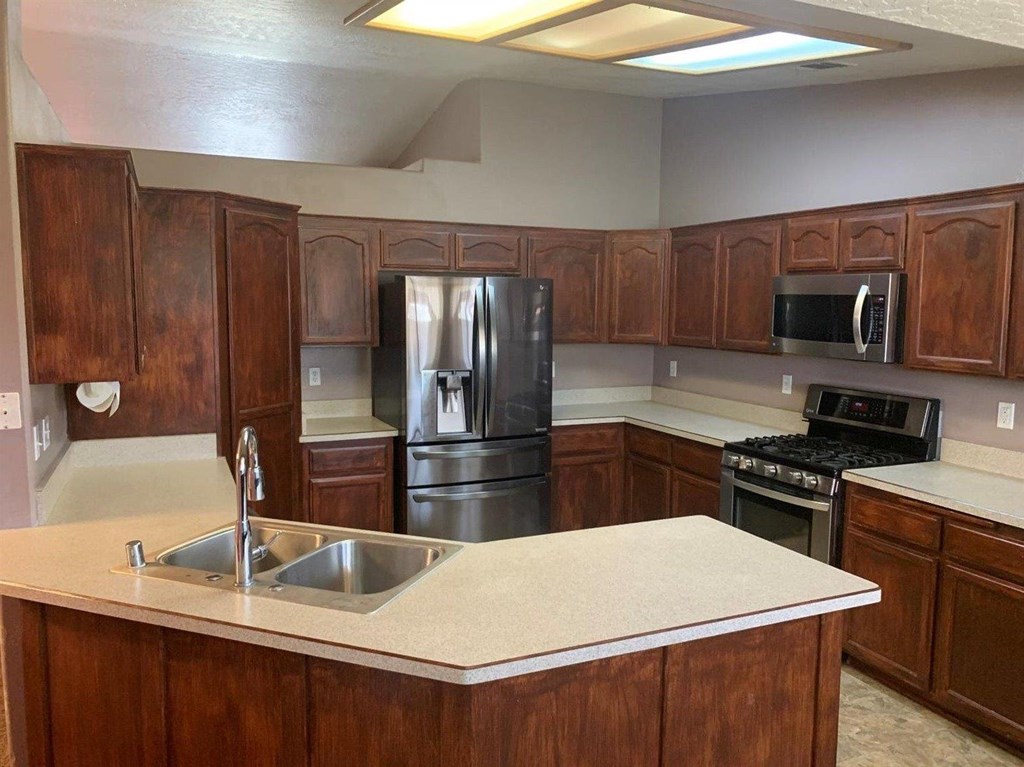 15006 Temecula Road Apple Valley, CA 92307 - Photo 8 of 13 a kitchen with a refrigerator sink and stove
