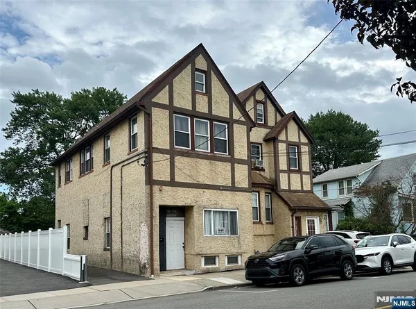 a car parked in front of a white building