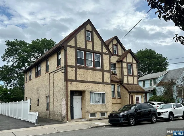 a car parked in front of a white building