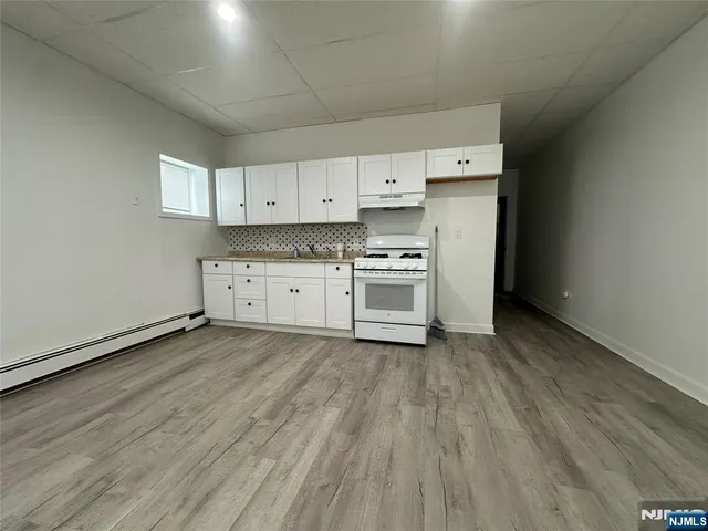 a view of a kitchen with stove and cabinets