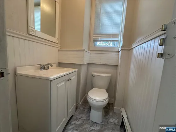 a bathroom with a toilet a sink and a window
