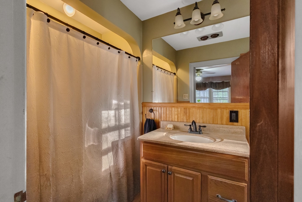 22 Williams Street Dudley, MA 01571 - Photo 15 of 33 a bathroom with a sink and mirror