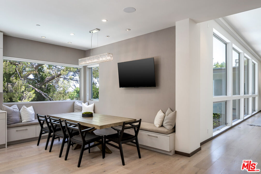15641 Meadowgate Road Encino, CA 91436 - Photo 15 of 32 a view of a dining room with furniture window and wooden floor