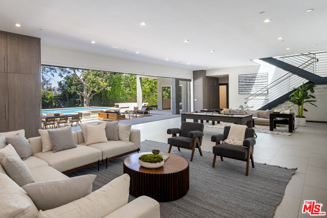 15641 Meadowgate Road Encino, CA 91436 - Photo 17 of 32 a living room with furniture and a large window