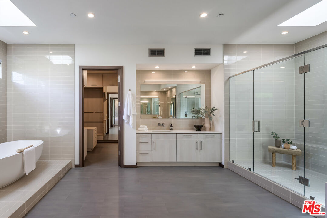 15641 Meadowgate Road Encino, CA 91436 - Photo 21 of 32 a bathroom with a double vanity sink toilet and shower