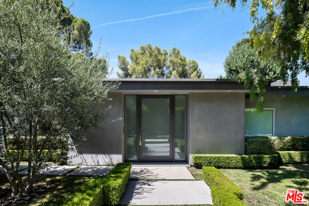 15641 Meadowgate Road Encino, CA 91436 - Photo 4 of 32 a front view of a house with a yard
