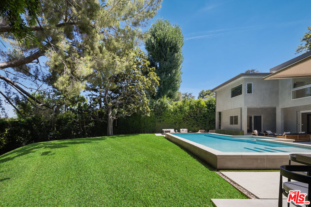 15641 Meadowgate Road Encino, CA 91436 - Photo 5 of 32 a view of a house with a big yard potted plants and large tree
