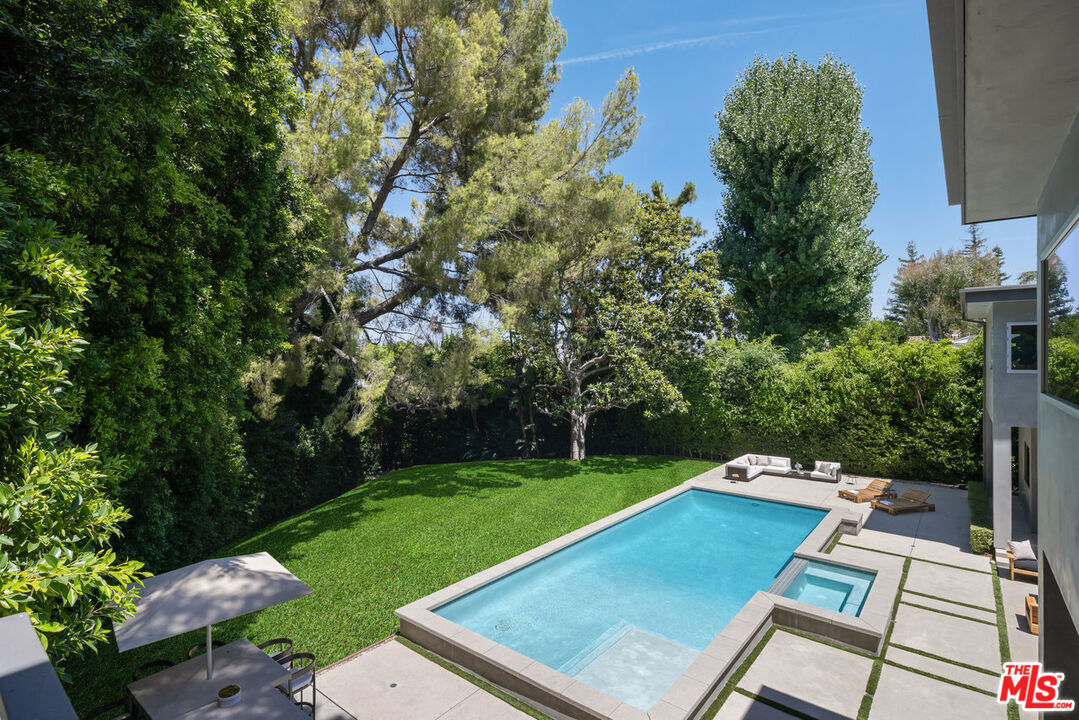 15641 Meadowgate Road Encino, CA 91436 - Photo 6 of 32 a view of a tennis ground with a large trees