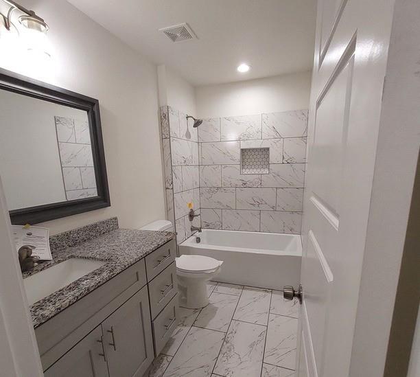 814 Chestnut Street Bonham, TX 75418 - Photo 7 of 12 a bathroom with a granite countertop sink toilet and shower