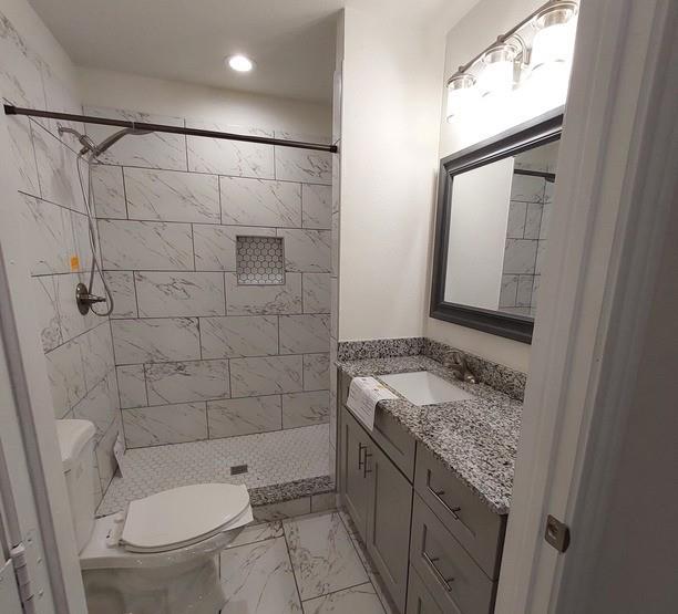 814 Chestnut Street Bonham, TX 75418 - Photo 9 of 12 a bathroom with a granite countertop sink toilet and shower