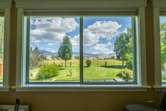 a view of a glass door with a view of the back yard