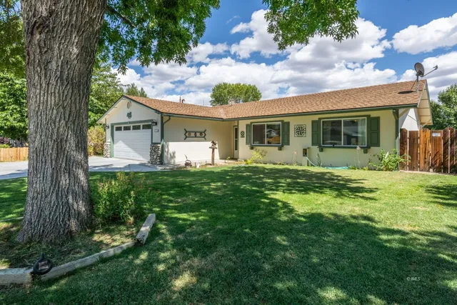 a front view of house with yard and green space
