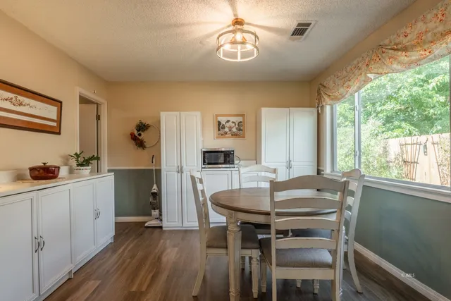 a view of a dining room with furniture window and outside view