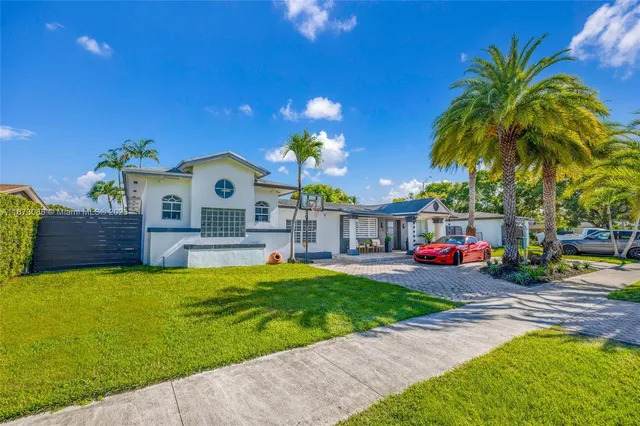 a view of a house with swimming pool yard and sitting area