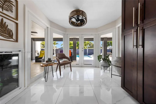 a dining room with furniture and a large window