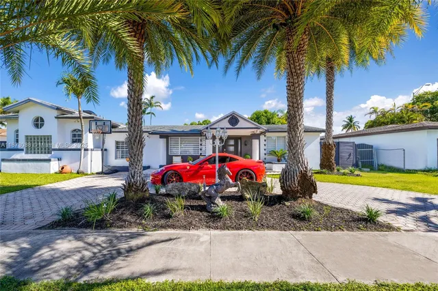 a view of a house with swimming pool and a yard