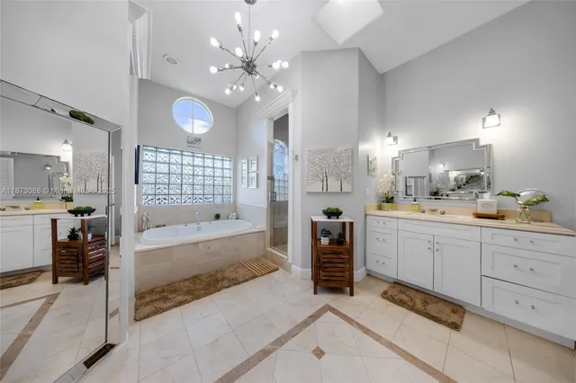 a large bathroom with a large tub vanity sink and mirrors