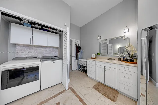 a kitchen with white cabinets and white appliances