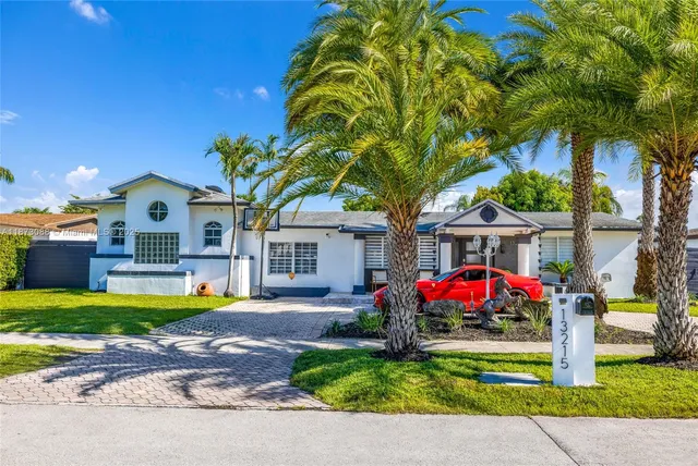 a front view of house with yard swimming pool and outdoor seating