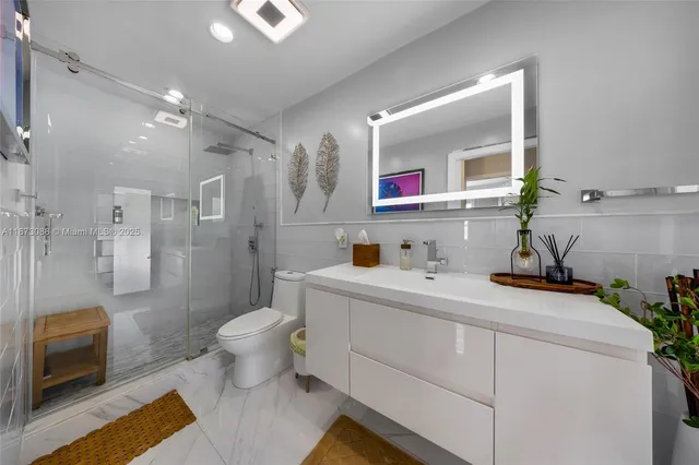 a bathroom with a sink toilet and shower