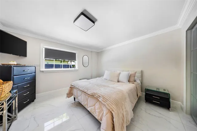 a bedroom with a bed and a tv