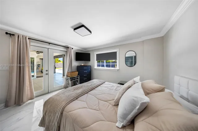 a bedroom with a large bed and a tv