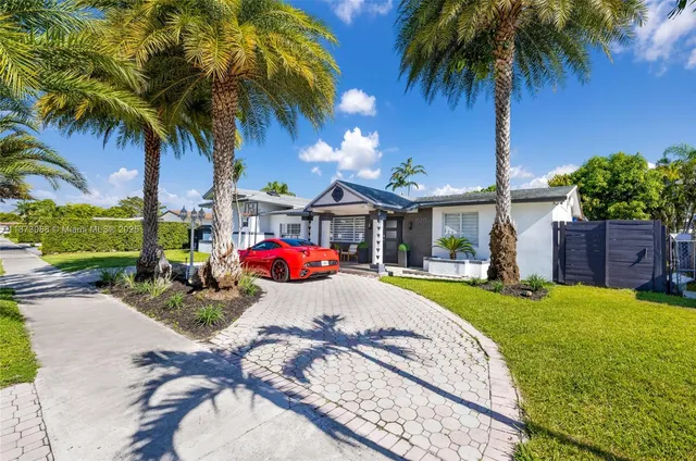 a view of a house with swimming pool and a yard