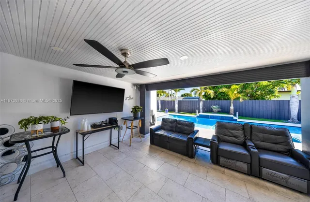a outdoor living space with furniture and a flat screen tv