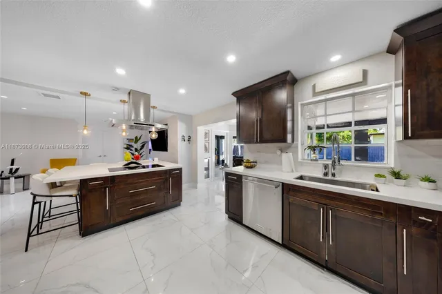 a kitchen with cabinets a sink and appliances