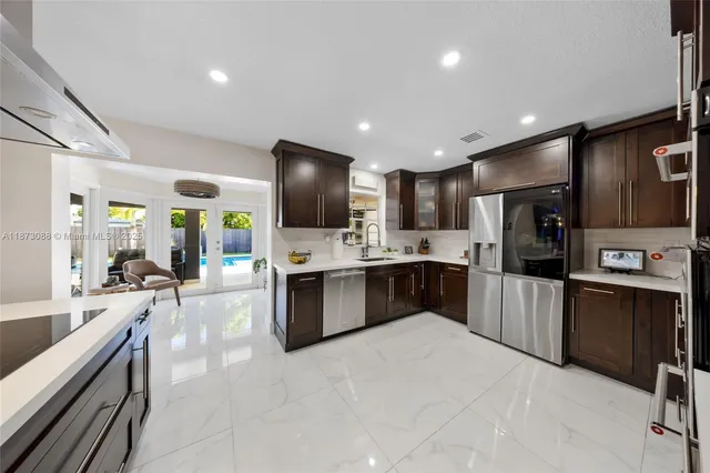 a large kitchen with stainless steel appliances kitchen island granite countertop a large counter top stainless steel appliances and cabinets