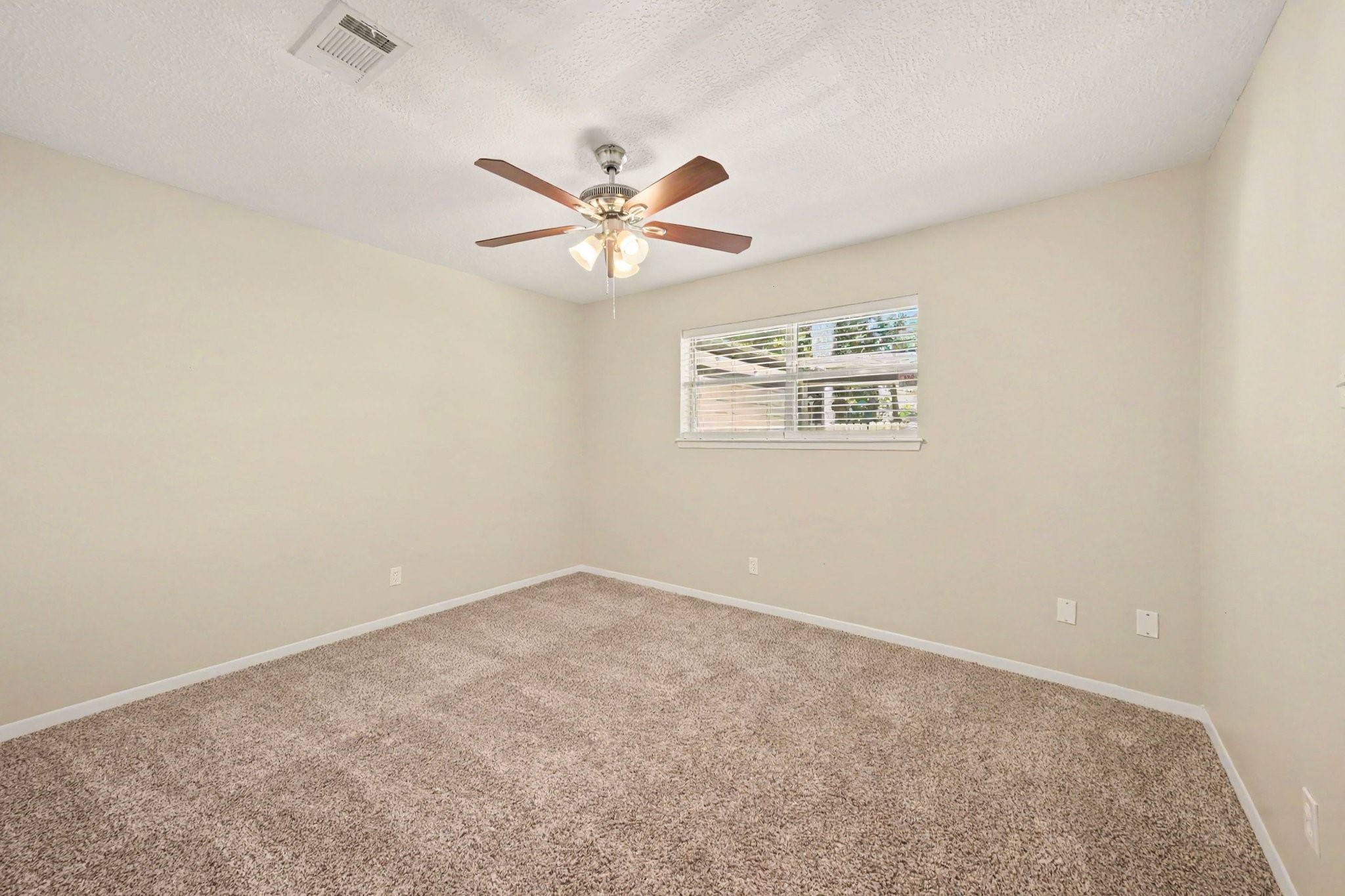 17419 Cassina Drive Spring, TX 77388 - Photo 26 of 35 an empty room with a window and a ceiling fan