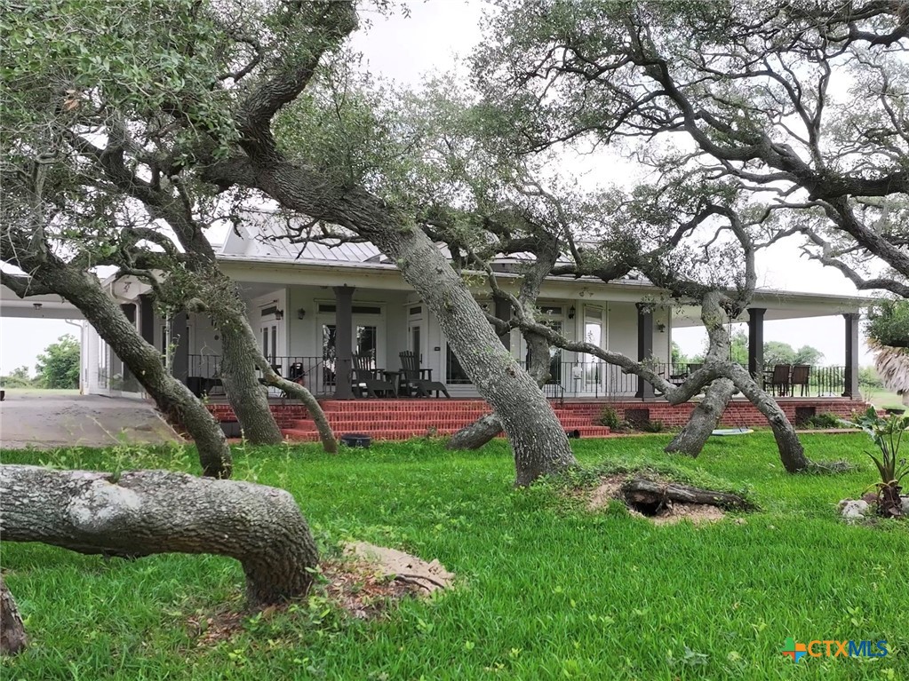 a view of a house with a yard porch and sitting area
