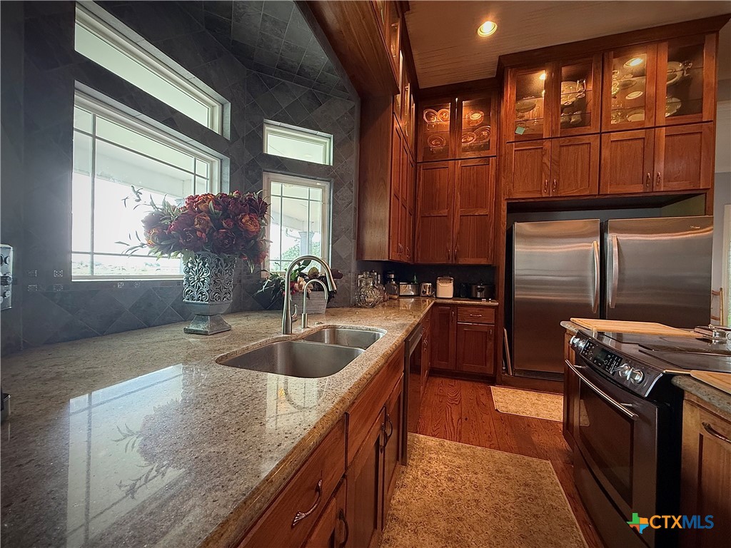 257 Whitaker Road Port Lavaca, TX 77979 - Photo 18 of 37 a kitchen with stainless steel appliances granite countertop a sink and a stove