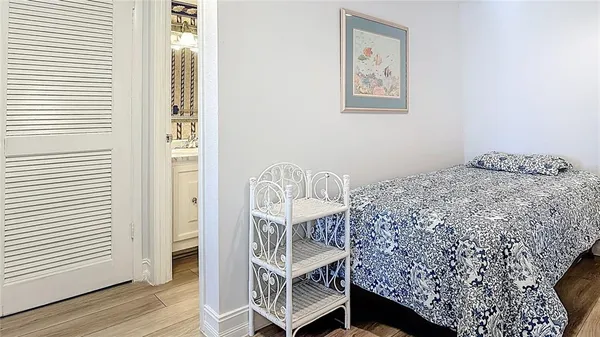 a view of a bedroom with wooden floor