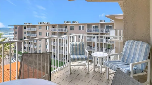 a view of a balcony with two chairs and a table