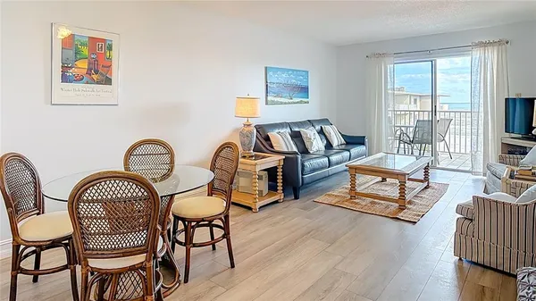 a living room with furniture a rug and a window