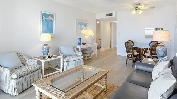 a living room with furniture a chandelier and a window