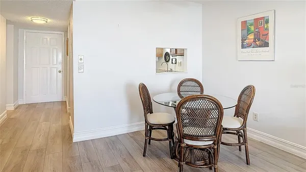 a view of a dining room with furniture and wooden floor