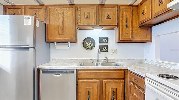 a kitchen with stainless steel appliances granite countertop a refrigerator and a stove