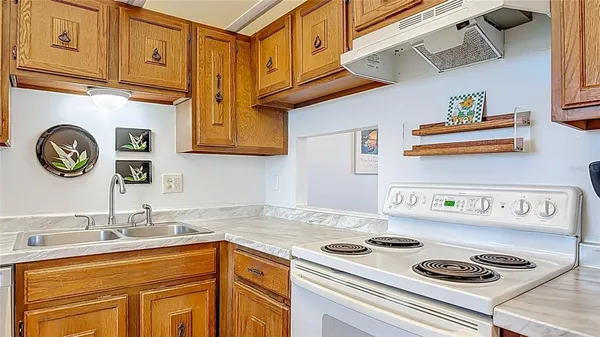 a kitchen with stainless steel appliances granite countertop a sink and a stove