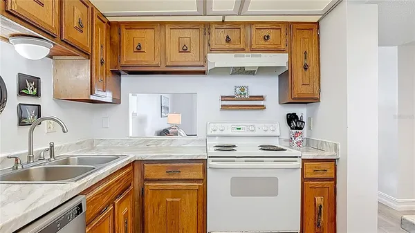 a kitchen with stainless steel appliances granite countertop a sink stove and cabinets