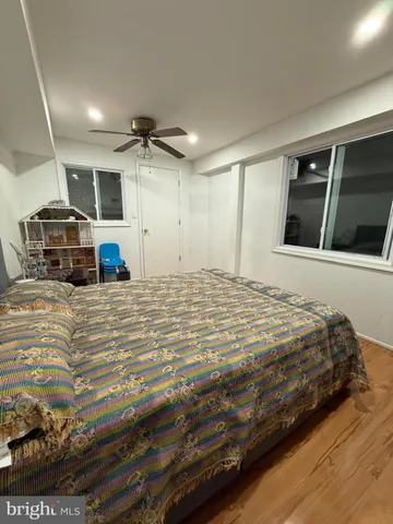 a large bed sitting in a room next to a lamp